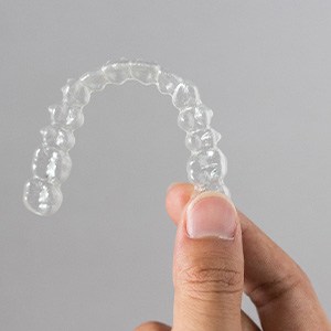 Patient holding clear aligner
