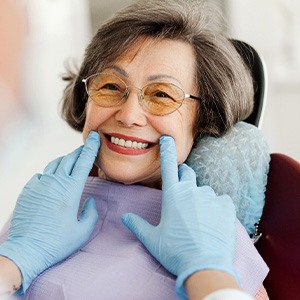 Dentist looking at patient's smile in treatment chair