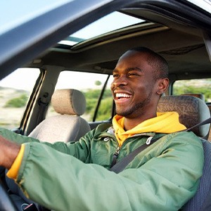 Smiling man drives away