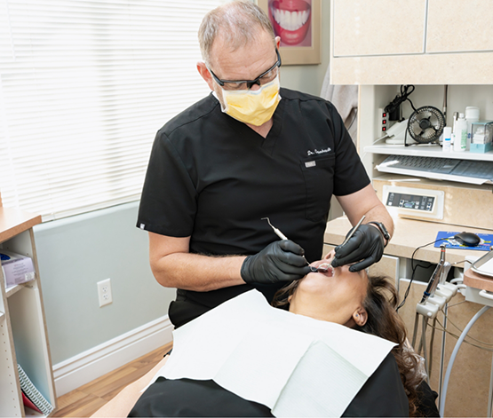 Doctor O giving a patient a dental exam