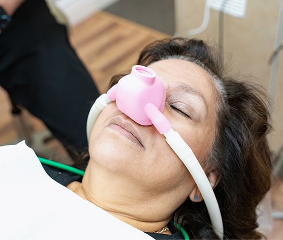 Dental patient relaxing with a nitrous oxide mask over their nose