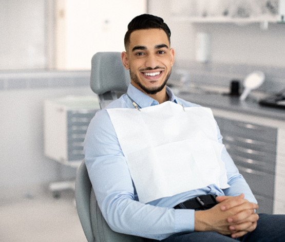 Patient smiling while sitting in treatment chair