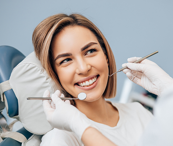 Woman smiling at her dentist during a checkup