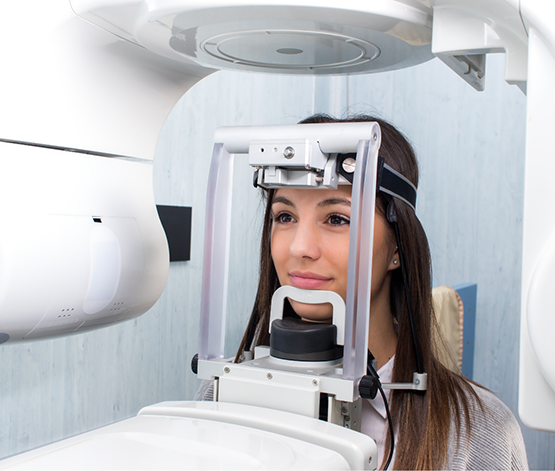 Dental patient getting a C T cone beam scan of her mouth and jaw