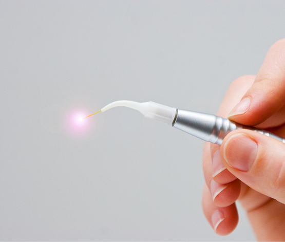Hand holding a pen like dental device