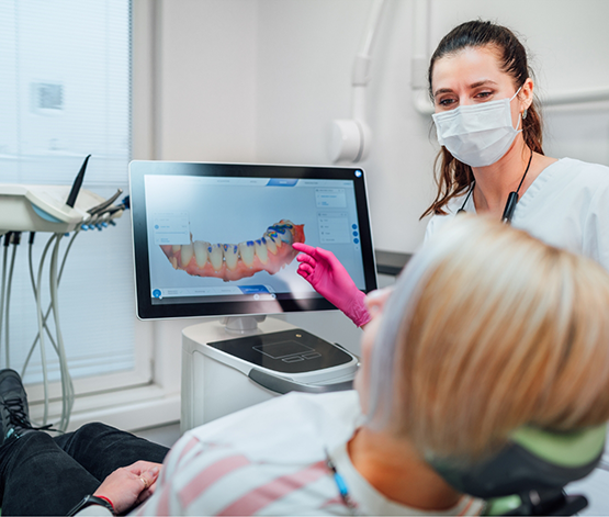 Dentist showing a patient a digital impression of their teeth on a monitor