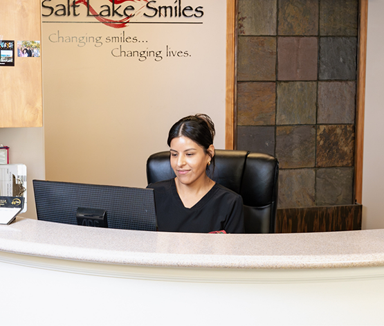West Jordan dental team member sitting at front desk